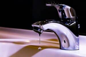 stainless steel faucet on white ceramic sink